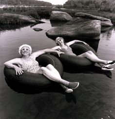 two women are floating on inflatable tubes in the water