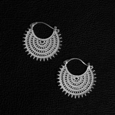 An exquisite fusion of heritage, these Afghan-inspired hoop earrings transcend craftsmanship with meticulous lacework adornments. More than accessories, they symbolize a revival of antiquity, featuring a delicate interplay of geometric shapes, graceful curves, and ornate filigree work. Radiating delicate elegance, they whisper a subtle yet profound statement in both style and substance. Design: by NOIR KĀLA Material: 925 Silver Size: 32 mm x 32 mm Weight: 8 g (pair) Geometric Shapes, Etsy Earrings, 925 Silver, Hoop Earrings, Jewelry Earrings, Etsy Uk, Lace, Silver