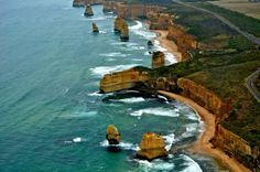 an aerial view of the great ocean road near australia's great ocean road, with twelve rock formations in the foreground