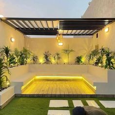 an outdoor living area with grass and lights