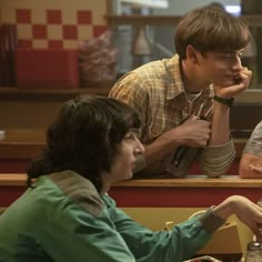 three people sitting at a table eating food