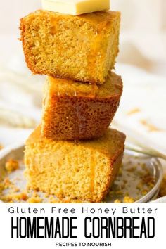 Photo of 3 large slices of thick cornbread, stacked on top of each other with a thick slice of butter on the top and honey drizzled over them, sitting on top of a plate with cornbread crumbs and a kitchen towel sitting around it with text that says Gluten Free Honey Butter Homemade Cornbread.