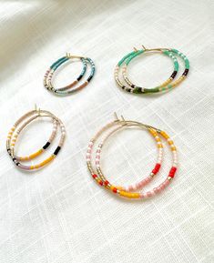 Colorful beaded design on gold plated hoops. Very light weight.  Made with very high quality Japanese beads. Size: 3 cm / 1.25 inch hoops. 🌎 Packaging 🌎 To be environmentally responsible about packaging we will package orders together in the same box. If certain items in your order are intended as gifts and you'd like individual boxes, please leave a note during checkout. Thank you for visiting and don't hesitate to message should you need to ask any questions at all.  To view more items from Package Orders, Seed Bead Hoop Earrings, Hoop Earrings Diy, Wire Wrapped Stone Jewelry, Japanese Beads, Earrings Colorful, Wire Wrapping Stones, Earrings Beaded, Back Jewelry