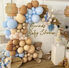 a baby shower with balloons, teddy bears and other items on the floor in front of it