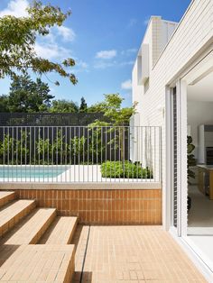 an outdoor swimming pool with steps leading up to it