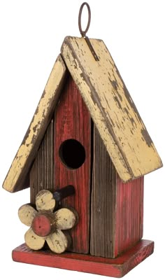 a wooden birdhouse with logs on the outside