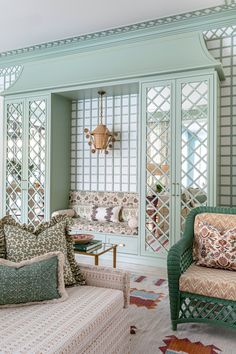 a living room filled with furniture and lots of green paint on the walls in front of them