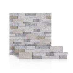 a white brick wall with grey and beige bricks on it's sides, against a white background