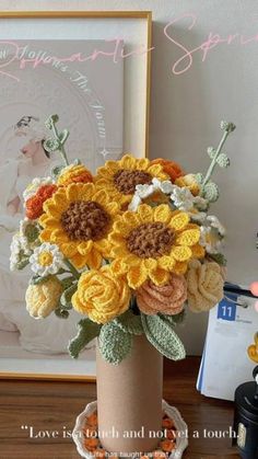 a crocheted vase filled with yellow and orange flowers