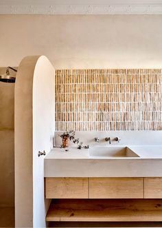 a bathroom with two sinks and a bamboo wall