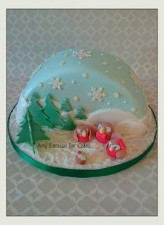 there is a cake that looks like it has been decorated with snowmen and trees