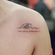 a person with a tattoo that says you only live once on their left shoulder and the word'you only live once'in red ink