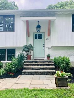 a white house with steps leading up to the front door