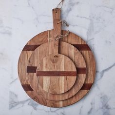 two wooden cutting boards on a marble counter top