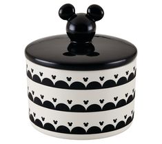 a mickey mouse cookie jar with black and white designs on the lid is shown in front of a white background