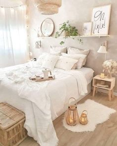 a bedroom with white bedding and pillows, wicker baskets on the side table