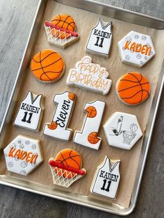 decorated cookies in the shape of basketballs and numbers