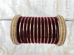 The perfect fusion of tradition and style, designed to elevate your outfit with elegance and charm. This stunning bangle set offers the versatility you've been searching for, as it can be tailored to adorn one hand, ensuring that you shine in any setting. This set includes a total of 24 colored bangles, carefully selected to complement a wide range of outfits and moods. 2 stunning Kara bangles add a touch of mystique and allure to your ensemble, and 11 plain insert bangles, offering a clean and classic finish to your overall aesthetic. NOTE: Bangle sets are fully customisable!! If you wish to change the colour of this bangle: 1. Choose a colour from the plain bangle section from our shop page. 2. Take a screenshot of the bangle set  3. send us a message, please note your order name, the sc Adjustable Bangle Bracelet For Diwali, Adjustable Hand-set Bangle For Celebrations, Adjustable Hand Set Bangle For Celebration, Traditional Festive Stackable Bracelets, Festive Traditional Stackable Bracelets, Traditional Festive Stackable Bangle, Elegant Adjustable Bangle For Festivals, Elegant Adjustable Bangle For Diwali, Festive Wedding Cuff Bracelet Adjustable