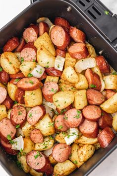 a pan filled with cooked sausage and potatoes