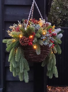 a hanging basket filled with christmas decorations and lights