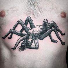 a man's chest with a black and white drawing of a spider on it