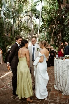 a group of people standing next to each other in front of a table covered with white cloths