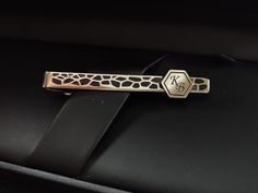 Adds a touch of class to any outfit with our unique silver patterned tie bar with initials engraved, that is a sophisticated and stylish accessory for every real men. These initials engraved tie clip is a must-have accessory in his wardrobe. Each of our monogrammed brass tie clips are handcrafted with precision and care, ensuring a high-quality and unique product that is sure to impress. The best material gives it a classic and timeless look, while the hand-tooled pattern and  blueing technique adds a touch of modernity and elegance. Make it even more special by personalizing it with your loved one's initials. It's a perfect gift for any occasion, including weddings, birthdays, anniversaries, or simply as a thoughtful gesture to show your appreciation. This tie clip is not only a stylish a Elegant Gold Rectangular Suit And Tie Accessories, Luxury Silver Jewelry With Engraved Logo, Elegant Silver Jewelry With Engraved Logo, Classic Formal Jewelry With Engraved Logo, Adjustable Silver Suit And Tie Accessories For Business, Elegant Adjustable Suit And Tie Accessories For Gifts, Formal White Gold Monogram Jewelry, Silver Suit And Tie Accessories For Father's Day Gift, Luxury Jewelry With Initials For Formal Occasions