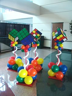 some colorful balloons are in the middle of a room