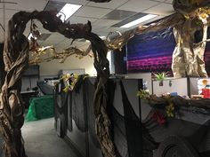 an office cubicle decorated for halloween with fake trees