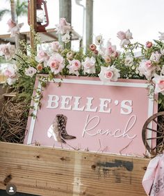 a pink sign with flowers on it that says, pelle's ranch in the center