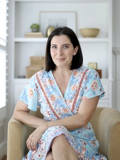 a woman sitting in a chair with her legs crossed