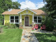 a yellow house with two red chairs in front of it and the words before written below