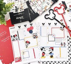 mickey mouse scrapbook pages are laid out on a table with scissors and other items