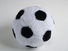 a black and white crocheted soccer ball sitting on top of a white table