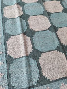 a blue and white blanket with squares on it