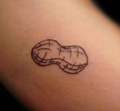 a small tattoo on the back of a woman's shoulder, with a piece of bread in it