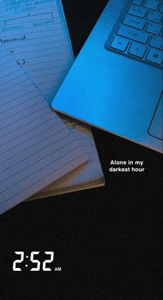 two notebooks sitting next to each other on top of a desk with a laptop