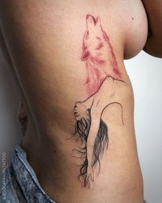 a woman's stomach with a wolf tattoo on her side and the bottom part of her body