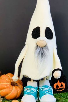 a stuffed toy is sitting next to some pumpkins