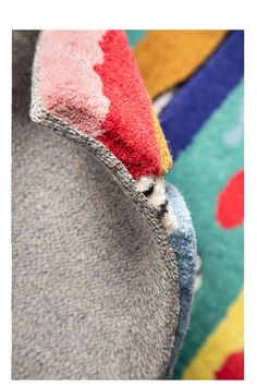 the back end of a colorfully colored jacket with holes in it's fabric