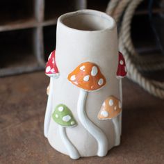 a ceramic vase sitting on top of a wooden table