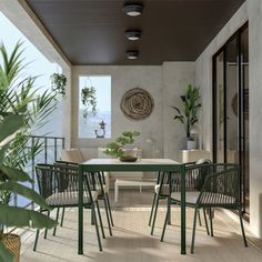 an outdoor dining area with green chairs and table