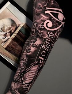 a man's arm with tattoos on it and an image of a skull in the background