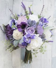 purple and white flowers are in a vase