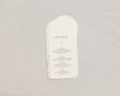 an open bookmark with the words let's eat on it sitting on top of a table