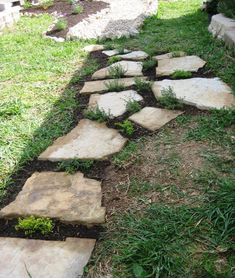 a garden path made out of stone blocks