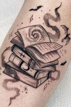 a black and white tattoo with books on it