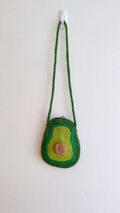 Felt avocado Crossbody Bags Designed in Florida by Ganapati Crafts Co. * Size: Approx. W 6" x H 8.5"  ; 16 x 22 cm * Strap: 35.5" ; 90cm * Material: 100% wool & Azo-free dyes * Handmade in Nepal with love💕 For more felt products, click here to visit my Etsy shop https://www.etsy.com/shop/GanapatiCraftsCo ✔ PERFECT GIFTS FOR KIDS Our cutest felt crossbody bag is handmade in Nepal of 100% wool. It is 3D designed and needle felted individually. It looks great from any angle. ✔ NATURAL FIBERS Our f Green Novelty Bags For Gifts, Green Novelty Bags For Daily Use, Green Novelty Rectangular Bag, Novelty Green Rectangular Bag, Felt Avocado, Bags For Kids, Felt Finger Puppets, Felt Fox, Bazaar Crafts