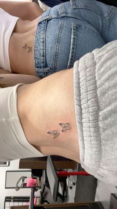 two women with small tattoos on their legs