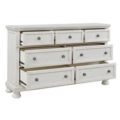 a white dresser with six drawers and two doors on the bottom shelf, in front of a